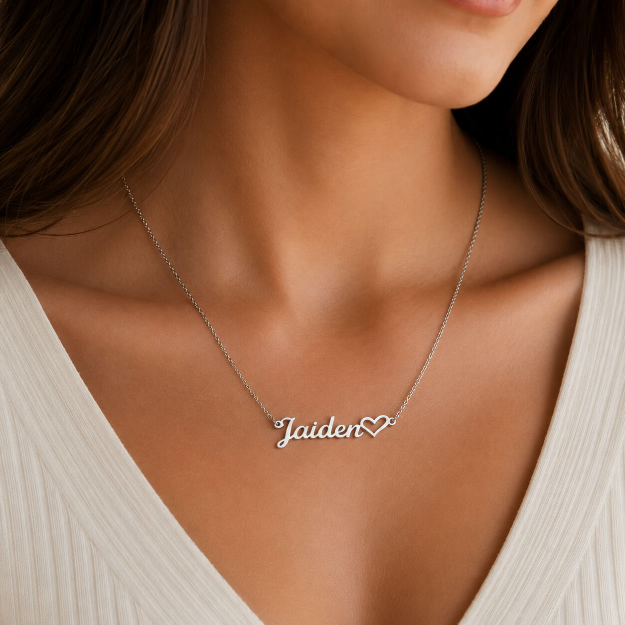 Close-up of personalized heart name necklace in silver