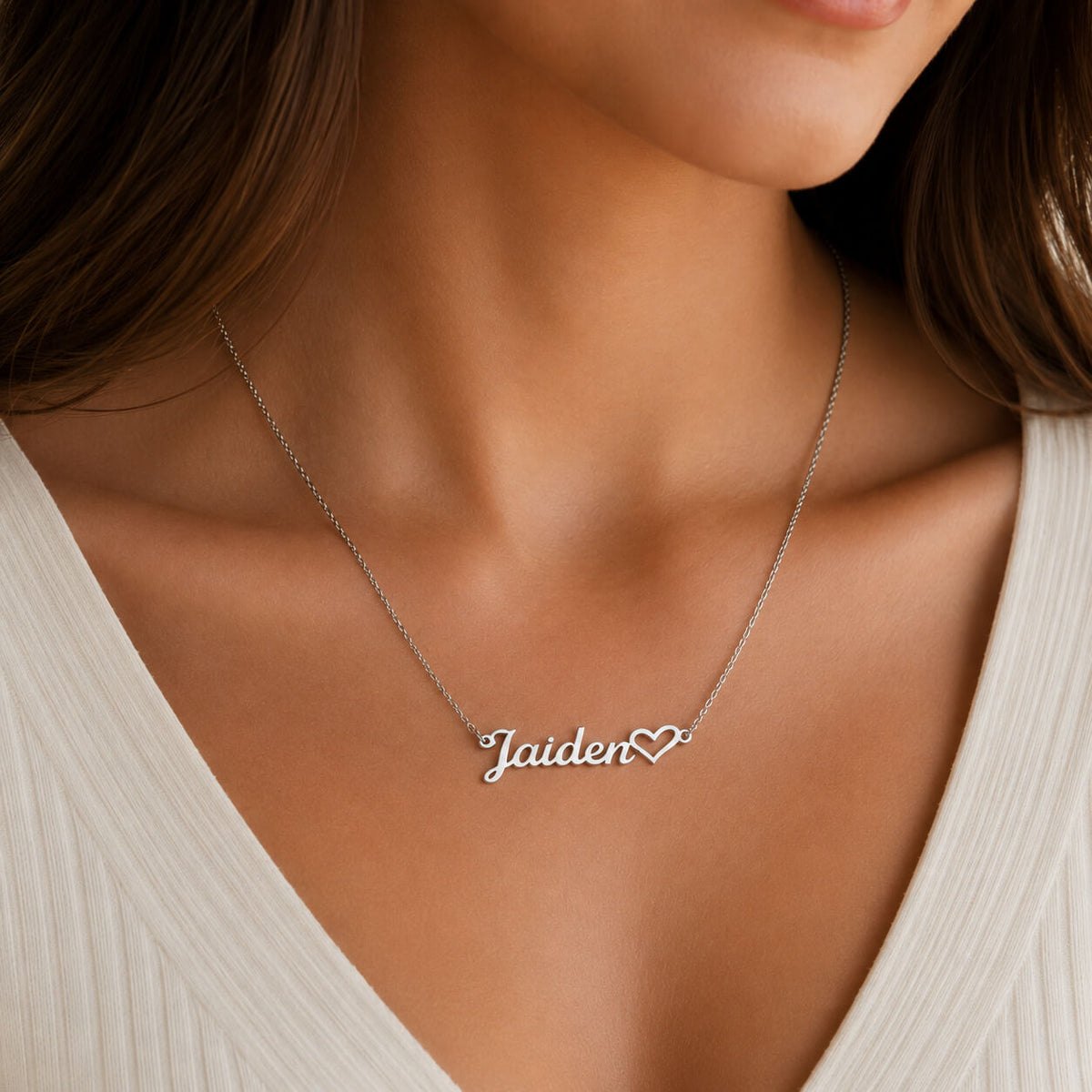Close-up of personalized heart name necklace in silver