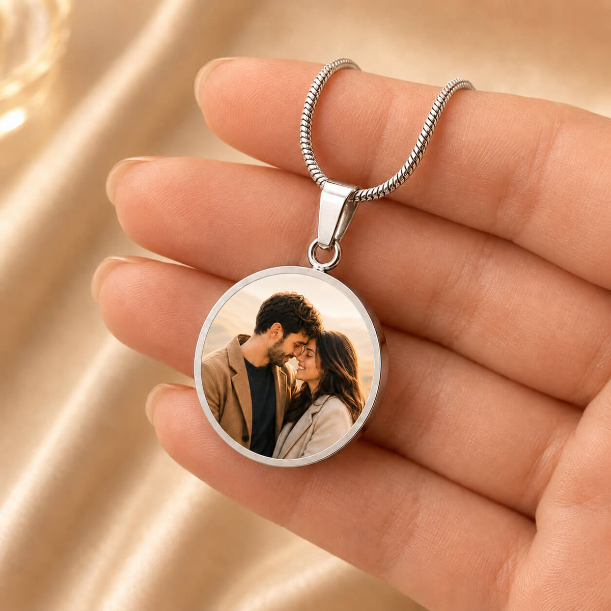 Personalized photo circle necklace in silver held in hand